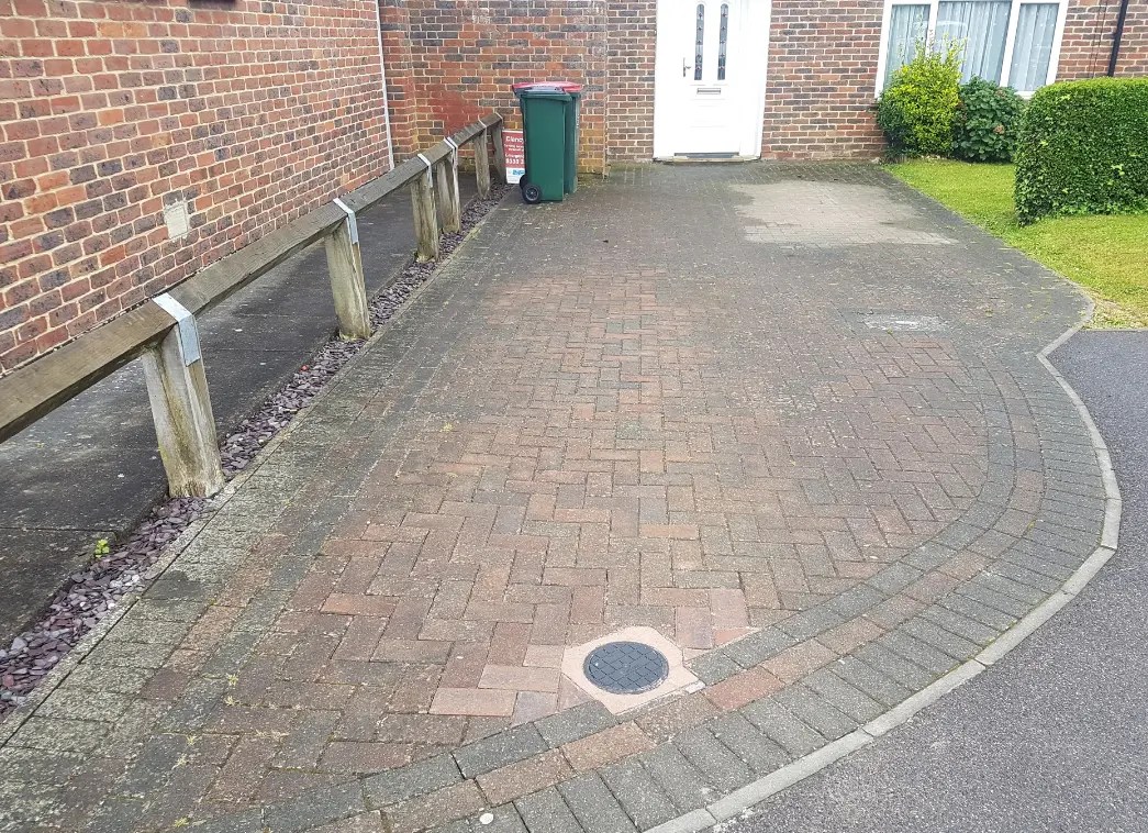 Block paved driveway before it has been pressure cleaned in Crawley