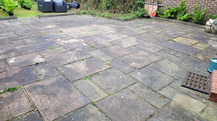 Natural sandstone patio before cleaning in Pound Hill Crawley